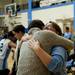Assistant varsity coach Cristal Jaaskelainen embraces Ari Axelrod after he finished singing the National Anthem on Friday. Axelrod was Jaaskelainen's student his freshman year. Daniel Brenner I AnnArbor.com